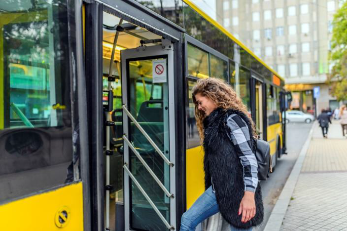 Frau steigt in Elektrobus ein